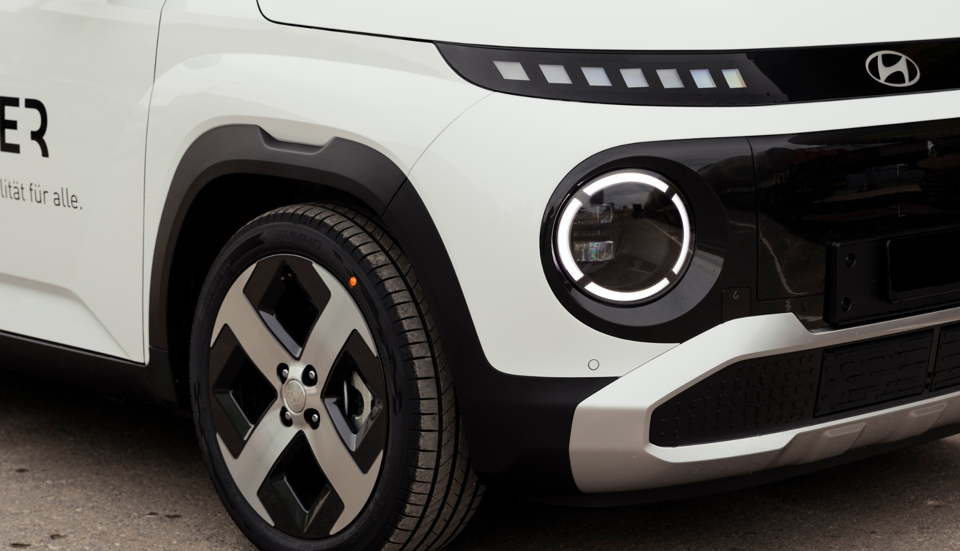 Nahaufnahme eines weissen Autos mit modernem Scheinwerferdesign.