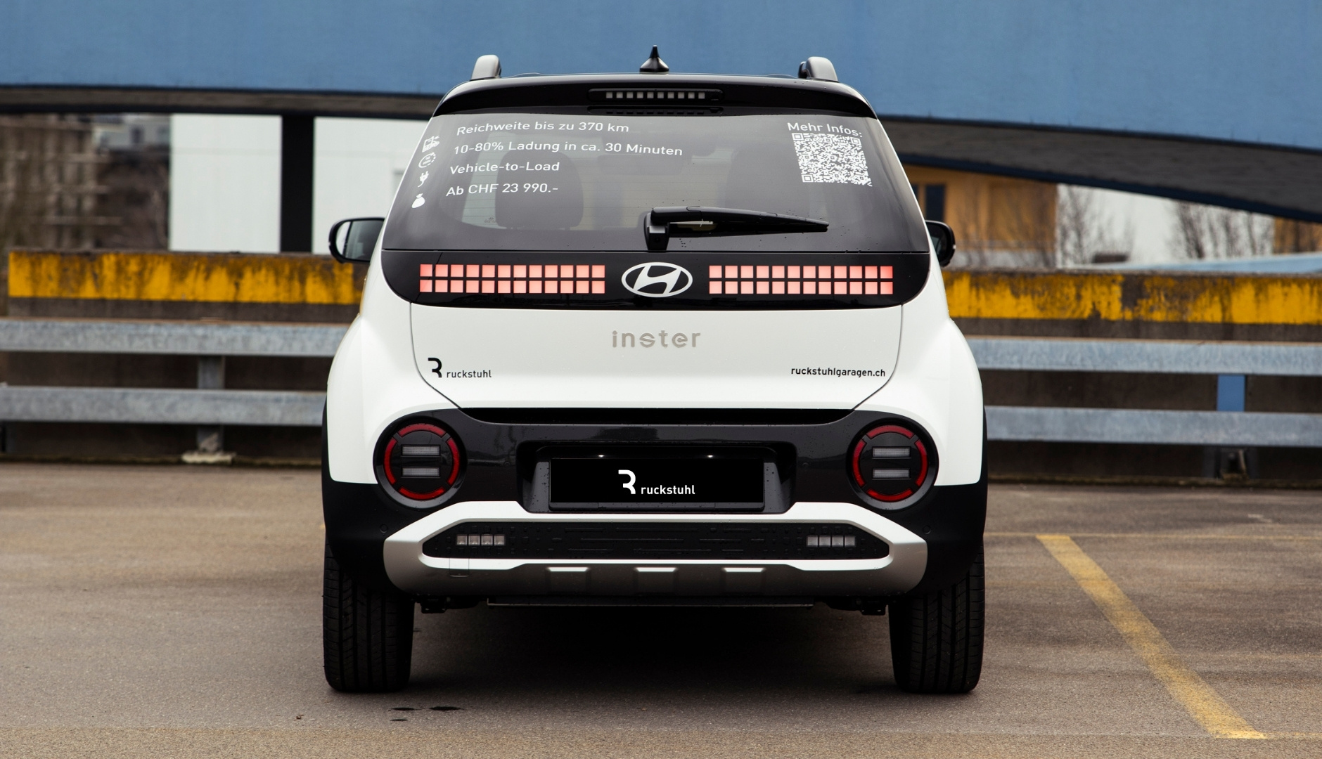 Rückansicht eines Hyundai-Fahrzeugs mit Ruckstuhl Garagen Logo auf einem Parkplatz.